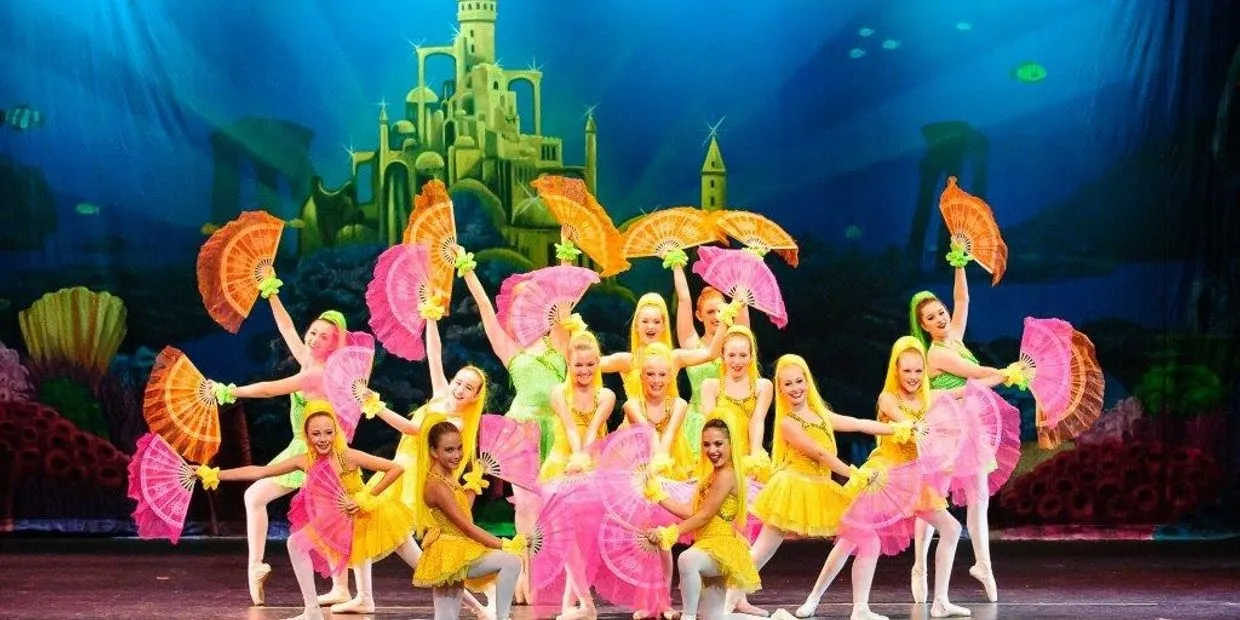 A group of women in yellow and pink costumes.