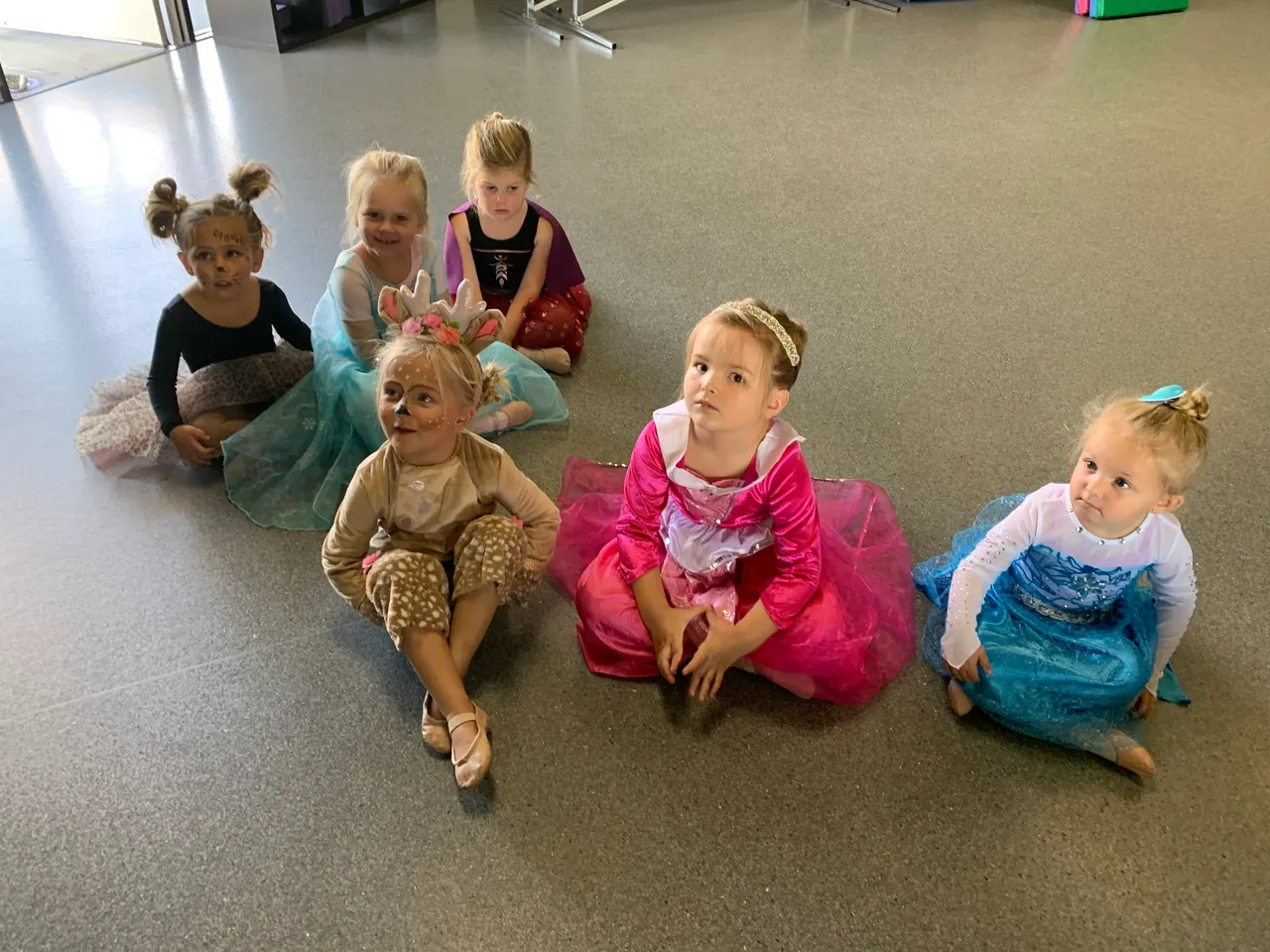 A group of little girls sitting on the floor